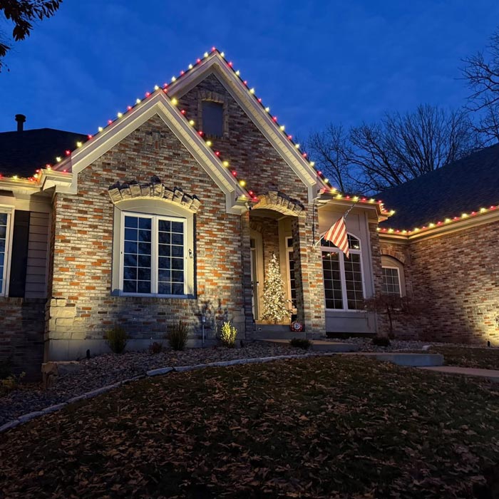 house with holiday landscaping lights